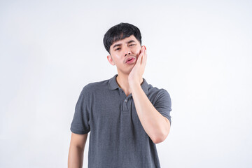 Portrait of handsome Asian man with mouth pain due to tooth decay and gingivitis. Medical and...