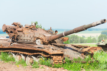 Burnt tank. Old defeated tank covered in rust. Consequences of military actions.