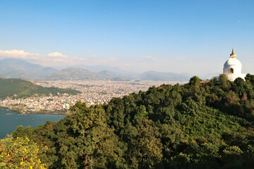 View onto the World Peace Pagoda in front ot the town of Pokhara at Phewa Lake, on the way up to...