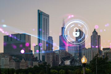 Cybersecurity symbol over a cityscape of modern skyscrapers at dusk.