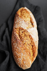 Fresh bread on a black napkin on a dark background