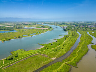 Aerial photo of a hiking trail through the flood plains along the Lek River with the Kuilenburgse train bridge crossing the river near Culemborg.