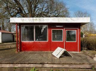 abandoned stall on the roadside, closed shop front, small red shack.