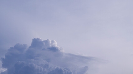 Blue sky background before rain. Fluffy sky clouds background with copy space. Cloudscape, freedom, nature view, soft cloudy, blue gradient, and landscape concepts. Blue-white gradient of sky texture.
