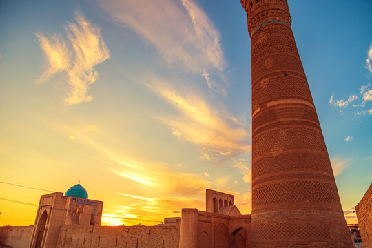 Poi Kalyan architectural ensemble - minaret, madrasah and mosque at sunset.