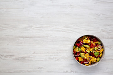 Healthy Fresh Corn Salad in a Bowl, top view. Flat lay, overhead, from above. Copy space.