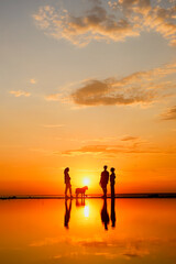 Fototapeta premium Silhouettes of people against sky seascape sunset sky on sea or ocean