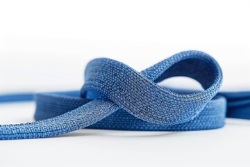 A close-up of a yoga strap being used for a seated forward fold