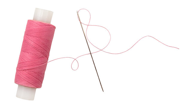 Old spool of thread and needle on a white background. Sewing accessories