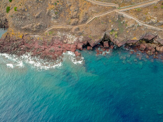 Rocky vulcanic beaches and high mountains of Sardinia island, Italy