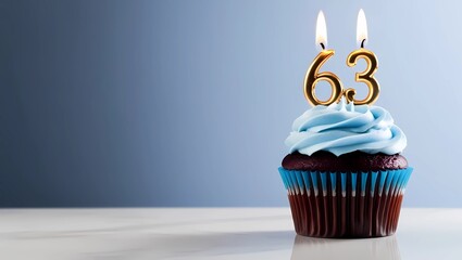 Golden Candle Number 63 on Blue Cupcake with Light Blue Frosting
