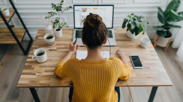 Person taking notes during a video call meeting about banking transfers, remote work, online discussion