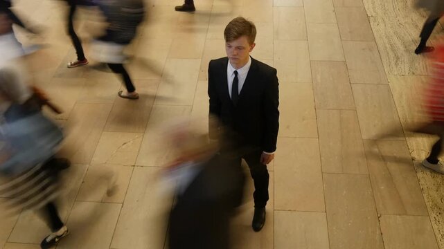 Businessman confidently standing amidst the hustle and bustle of a busy urban environment