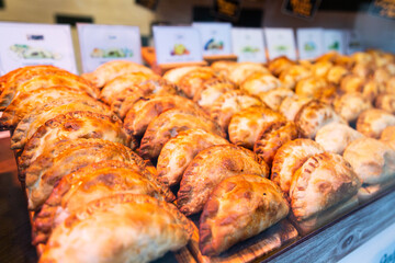 Freshly baked empanadas with different fillings for sale