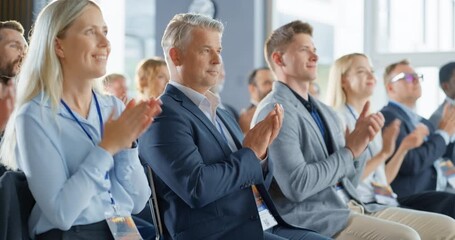 Male CEO Sitting in a Bright Crowded Auditorium at a Tech Conference. Confident Man Applauding After a Successful Keynote Presentation. Specialist Inspired by Latest Technological Advances.