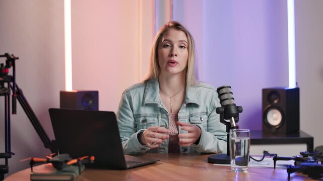 Woman, face and talking for recording podcast, live stream and speech notes on laptop in studio. Portrait, virtual chat and female commentator with computer, sport results and report on medal winners