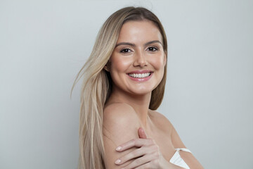 Happy excited woman with long blonde hair, studio portrait