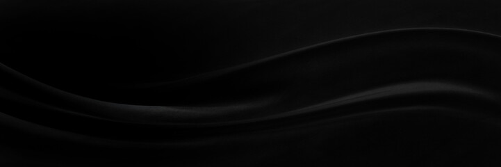Black gray satin dark fabric texture luxurious shiny that is abstract silk cloth panorama background with patterns soft waves blur beautiful.