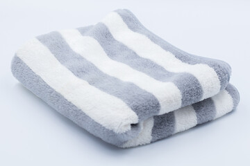 Clean bathroom towels laid out in rows, Rolled soft terry towel , Folded soft terry towel.