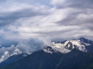 Close-up of mountain peaks adorned with snow caps, reflecting the power and beauty of the wild
