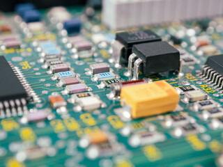 Close-up of microcircuits and components: chips, diodes and capacitors on a printed circuit board,...