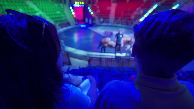 Spectators in a circus. Happy family with small child watching a circus performance. Little boy at circus. Simferopol, Crimea