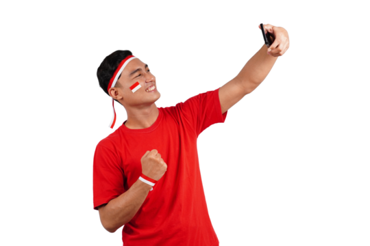 An Indonesian man celebrating Indonesia's independence day on 17 August while holding smartphone with blank screen isolated transparent