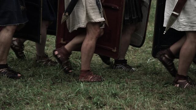 Roman Legionary soldiers moving in a historical battle in a systematic military formation