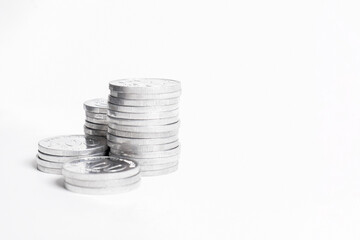 Coins stacks isolated on a white background. Silver coin money. Piles of shiny coins