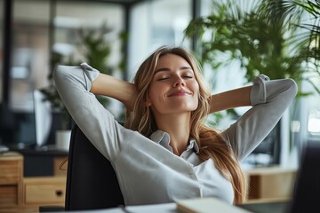 A woman is sitting in a chair with her arms crossed and a smile on her face. She is relaxed and content