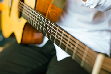 Close up man playing acoustic guitar