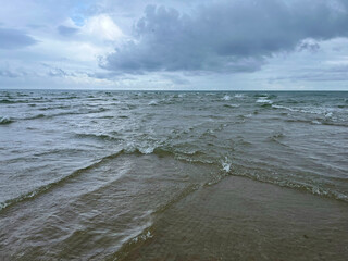 Sandbar spit at Skagen Odde called Grenen - a famous place where North and Baltic seas meet each other in a confluence. Junction between two seas in a rainy and cloudy weather