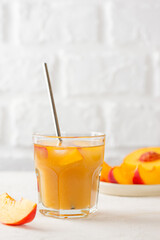 Refreshing peach and nectarine ice lemonade. Homemade cold summer drink. Vertical orientation.