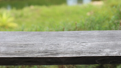 Fototapeta premium Empty wooden on blur green nature background. Ready for product display.