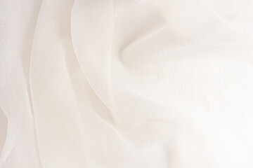 Stylish wedding background of beige delicate folds. Background illustrations of wedding decor. the soft folds of the waves of silk transparent fabric.