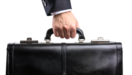 Close-up of a hand holding a black leather briefcase. Ideal for business concepts, corporate identity, and professional themes.