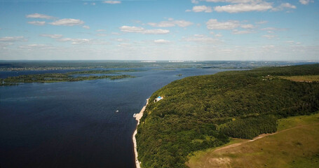 Monastery in the forest on the hilly bank of the river