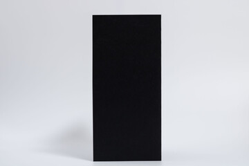 mockup of a black vertical brochure on a white horizontal background