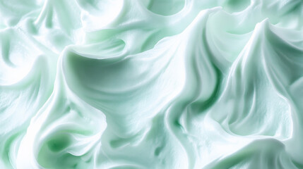 Fototapeta premium A mint abstract background with a light, frothy texture, reminiscent of whipped cream. The airy design adds a playful and whimsical touch.