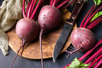 Ripe fresh beets on a wooden cutting board with knife. Food photography - Powered by Adobe