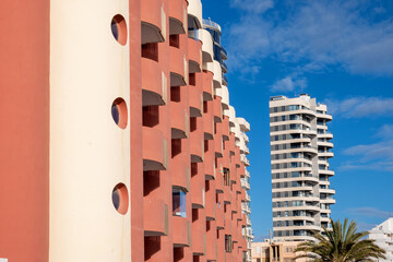 Modern high apartment building with flats for rent or sale.