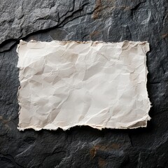 blank wrinkled paper over on a stone on a dark background