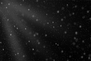 Gentle snowflakes descend gracefully against a dark evening sky, creating a serene winter atmosphere.