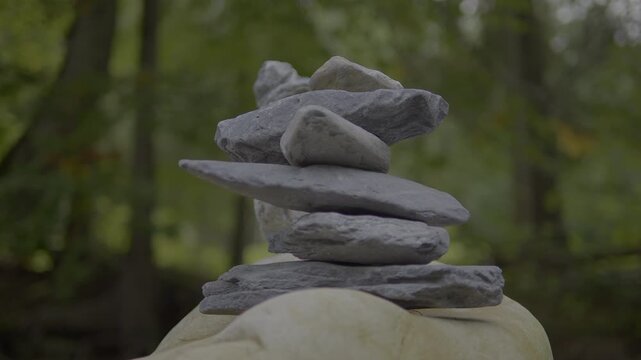 Balancing stones in a forest creates a serene environment for meditation and mindfulness