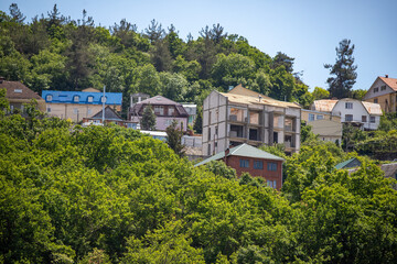 Residential buildings in a picturesque winter location on the slopes of green mountains.