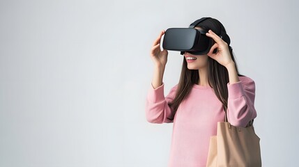 Woman in pink sweater smiles while using VR headset.