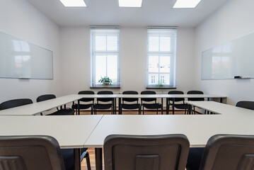 Conference room with benches, tables and a projector. Empty Conference Room In Modern Office....