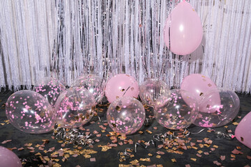 Balloons on a background of glitter and confetti