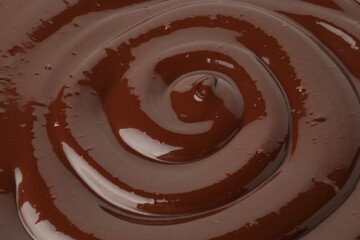 Tasty melted chocolate as background, closeup view