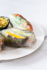 Savor the authentic taste of Vietnamese spring rolls with rice paper, fresh vegetables, salmon, and fish sauce, blending the best of Asian and Thai cuisine in a healthy, refreshing meal
